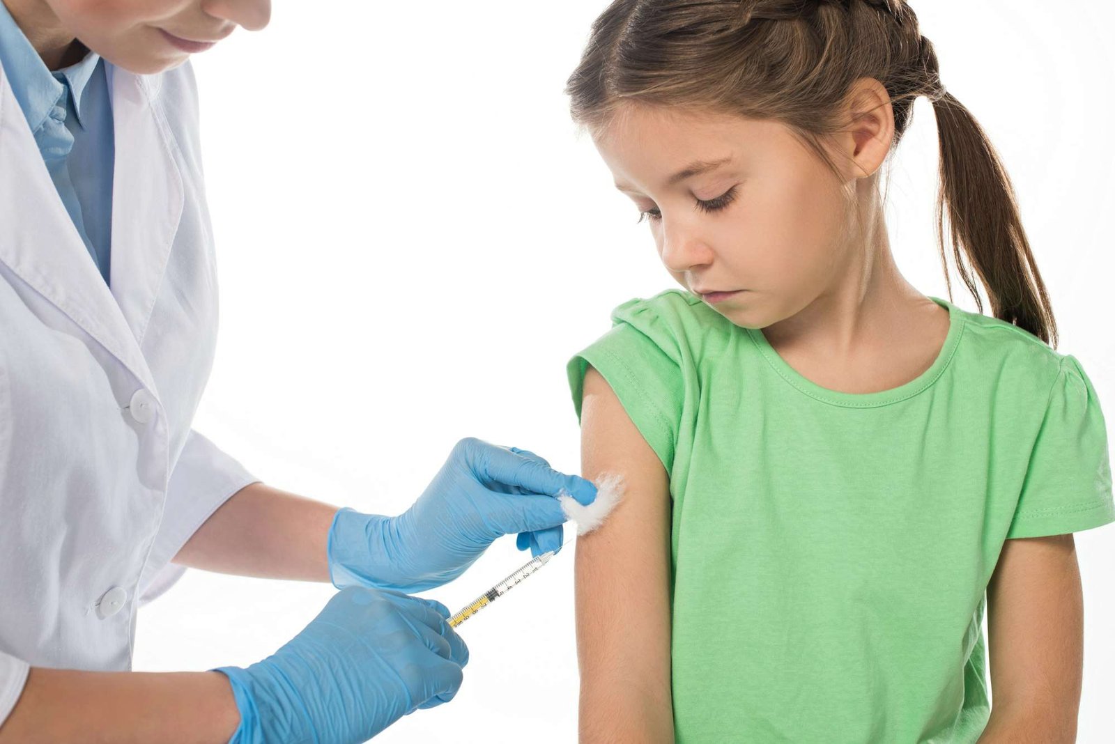 Pediatrician doing vaccine injection to kid isolated on white